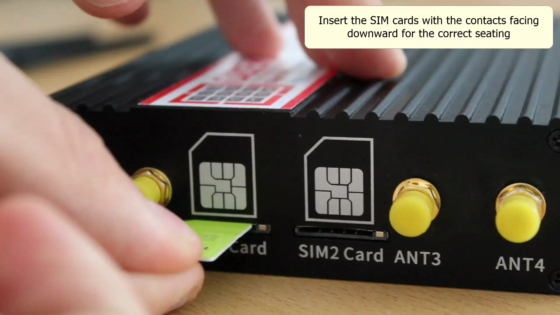 sim card being inserted into modem contacts facing the print and small icon